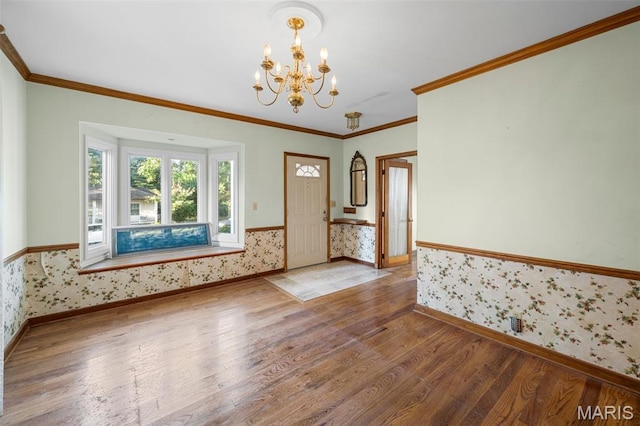 135 Oak Tree Dr, Webster Groves, MO 63119 - unfurnished room with wallpapered walls, wood finished floors, a chandelier, a wainscoted wall, and crown molding