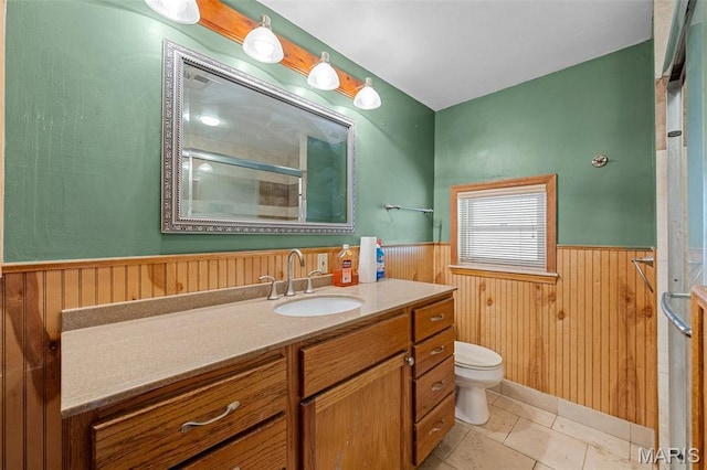 135 Oak Tree Dr, Webster Groves, MO 63119 - bathroom featuring wainscoting, vanity, a shower with door, wood walls, and tile patterned flooring