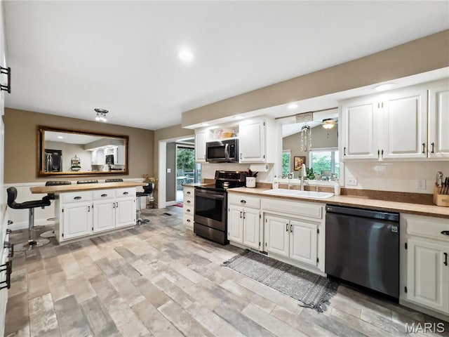 1171 Thunder Mountain Rd, Camdenton, MO 65020 - kitchen with stainless steel appliances, plenty of natural light, white cabinets, and recessed lighting
