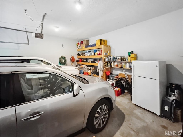 1171 Thunder Mountain Rd, Camdenton, MO 65020 - garage featuring freestanding refrigerator and a garage door opener
