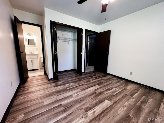 410 N Cleveland St, Fillmore, IL 62032 - unfurnished bedroom with wood finished floors, a ceiling fan, and ensuite bathroom