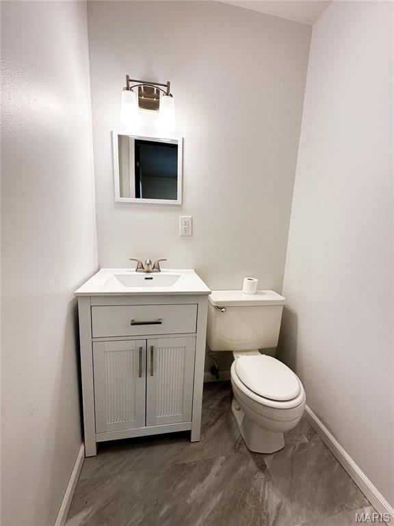 410 N Cleveland St, Fillmore, IL 62032 - half bath featuring vanity and marble finish floors