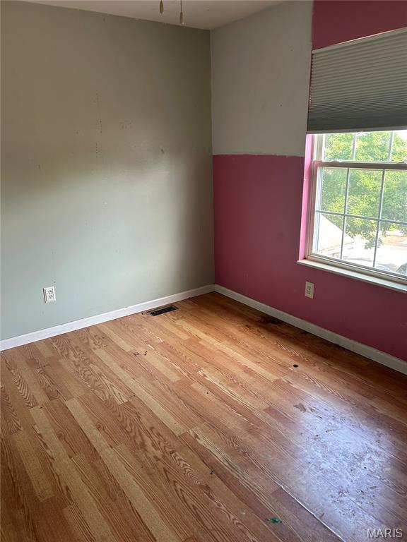 12922 High Crest St, Black Jack, MO 63033 - spare room featuring wood finished floors and baseboards