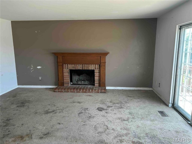 12922 High Crest St, Black Jack, MO 63033 - unfurnished living room featuring carpet flooring, healthy amount of natural light, and a fireplace
