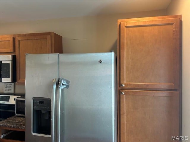 12922 High Crest St, Black Jack, MO 63033 - kitchen with appliances with stainless steel finishes, dark countertops, and brown cabinets