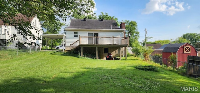 934 Raines Ave, Jackson, MO 63755 - rear view of property featuring a wooden deck, a chimney, a fenced backyard, a carport, and an outbuilding