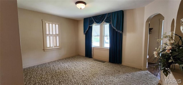 934 Raines Ave, Jackson, MO 63755 - carpeted empty room with arched walkways and baseboards