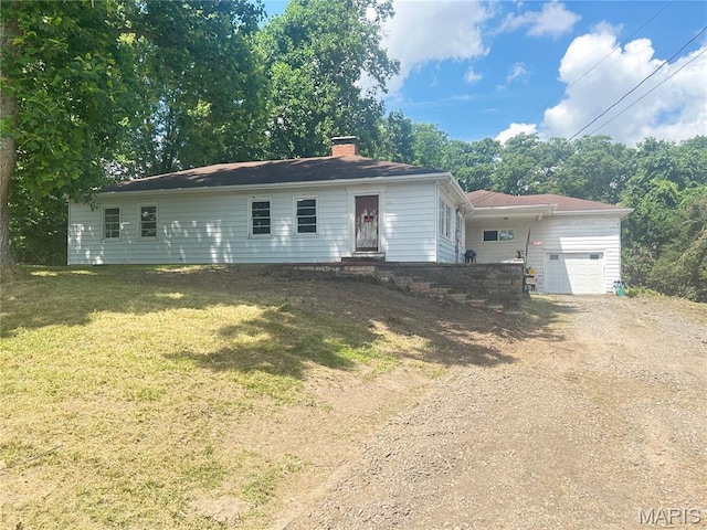 1203 N Main St, Salem, MO 65560 - view of front of home featuring driveway, a garage, a chimney, and a front yard