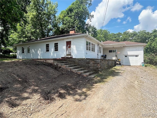 1203 N Main St, Salem, MO 65560 - view of front of house with an attached garage, driveway, and a chimney