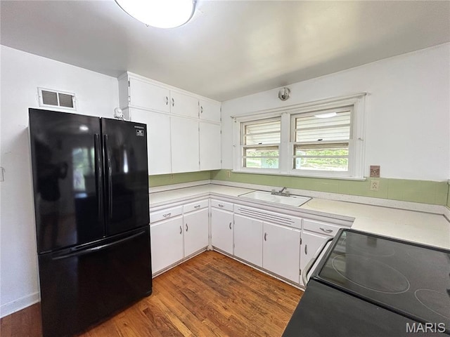1203 N Main St, Salem, MO 65560 - kitchen with freestanding refrigerator, electric range oven, light countertops, and white cabinetry