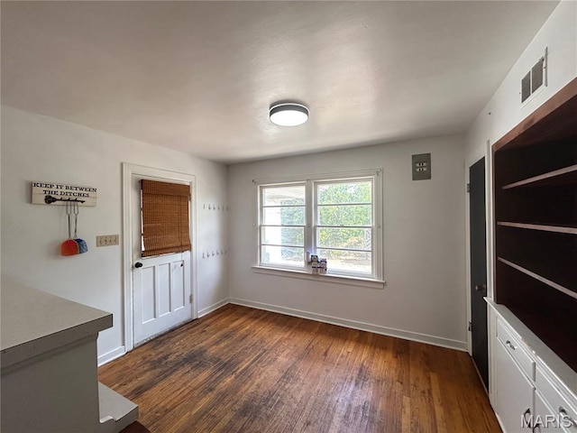 1203 N Main St, Salem, MO 65560 - unfurnished dining area featuring dark wood-style flooring and baseboards