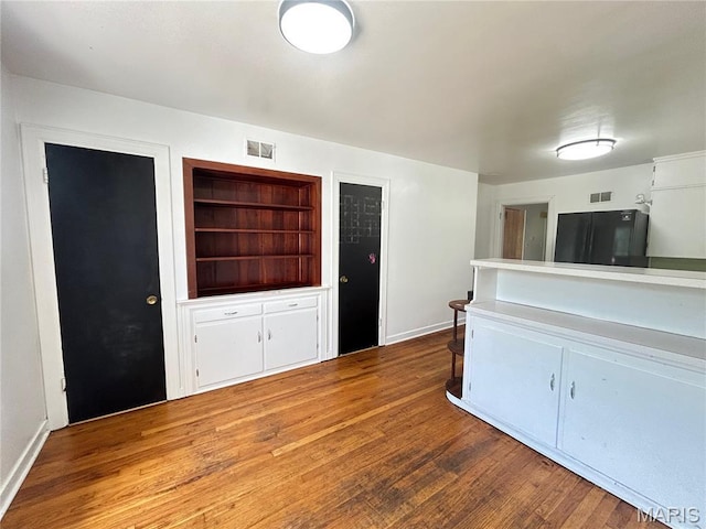 1203 N Main St, Salem, MO 65560 - unfurnished living room with wood finished floors and baseboards