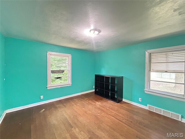 1203 N Main St, Salem, MO 65560 - spare room with wood finished floors and a textured ceiling