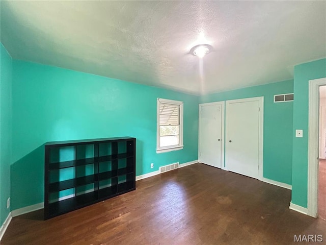 1203 N Main St, Salem, MO 65560 - unfurnished bedroom featuring wood finished floors and a textured ceiling