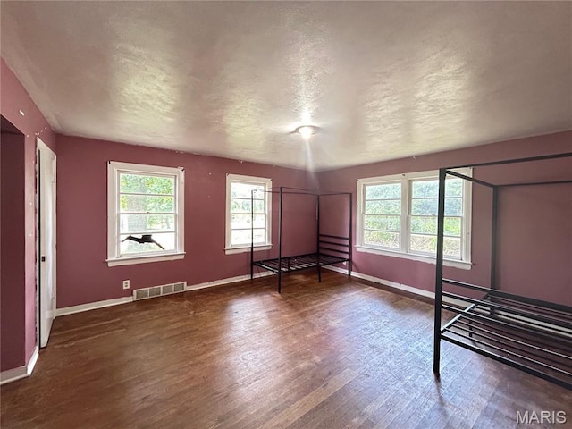 1203 N Main St, Salem, MO 65560 - unfurnished bedroom with wood finished floors and a textured ceiling