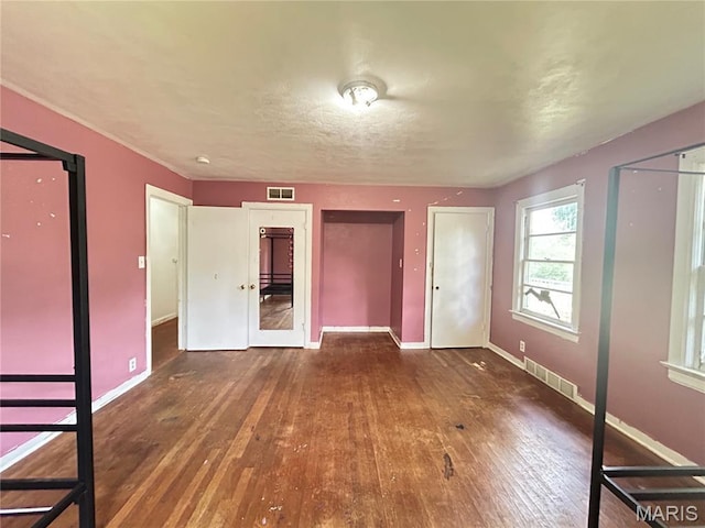 1203 N Main St, Salem, MO 65560 - unfurnished bedroom featuring hardwood / wood-style flooring and two closets