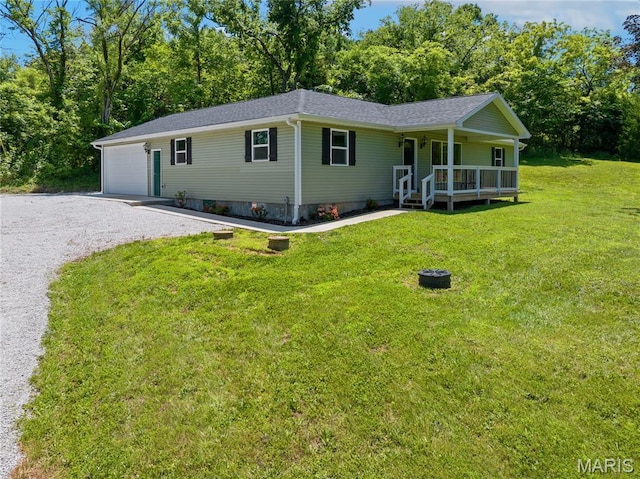 326 State Highway W Rd, Macks Creek, MO 65786 - view of front facade featuring a porch, a front lawn, a garage, gravel driveway, and a shingled roof