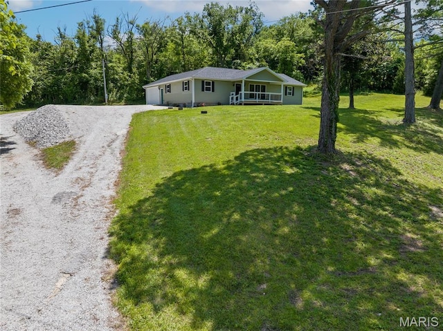 326 State Highway W Rd, Macks Creek, MO 65786 - single story home featuring gravel driveway, a front lawn, covered porch, a garage, and a forest view