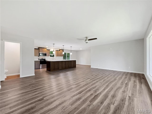 326 State Highway W Rd, Macks Creek, MO 65786 - unfurnished living room with wood finished floors and ceiling fan