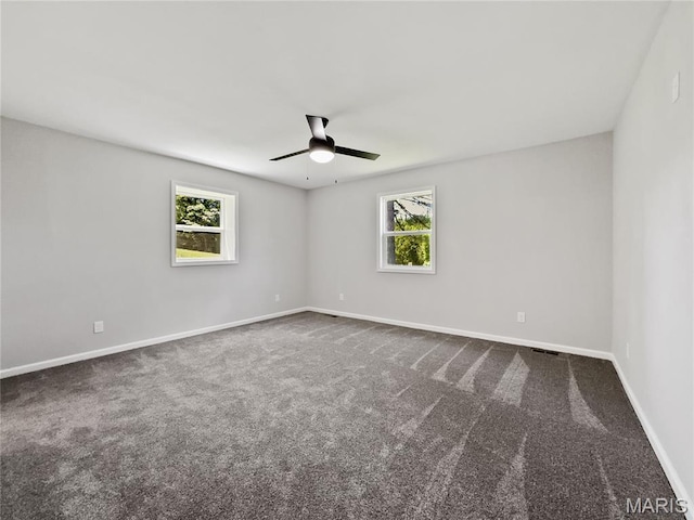 326 State Highway W Rd, Macks Creek, MO 65786 - spare room featuring a ceiling fan and dark colored carpet