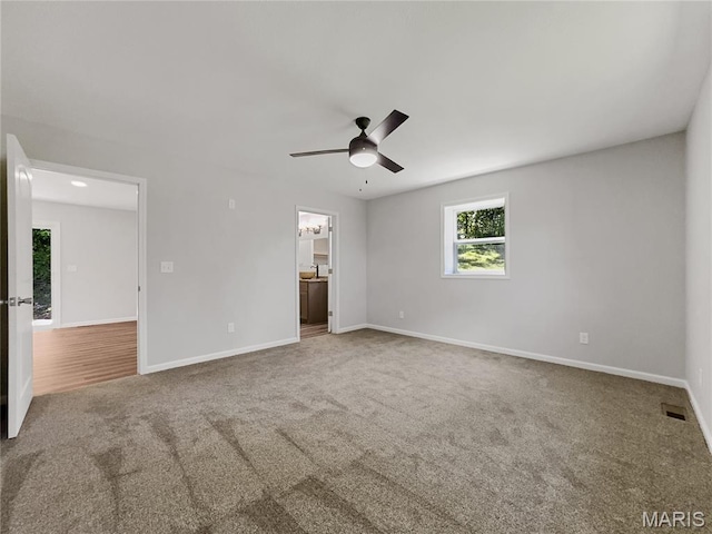 326 State Highway W Rd, Macks Creek, MO 65786 - unfurnished bedroom featuring carpet flooring, connected bathroom, and a ceiling fan