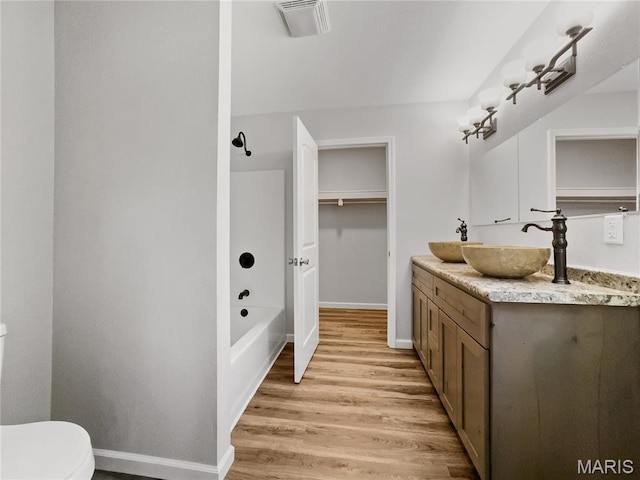 326 State Highway W Rd, Macks Creek, MO 65786 - bathroom with vanity, wood finished floors, and  shower combination