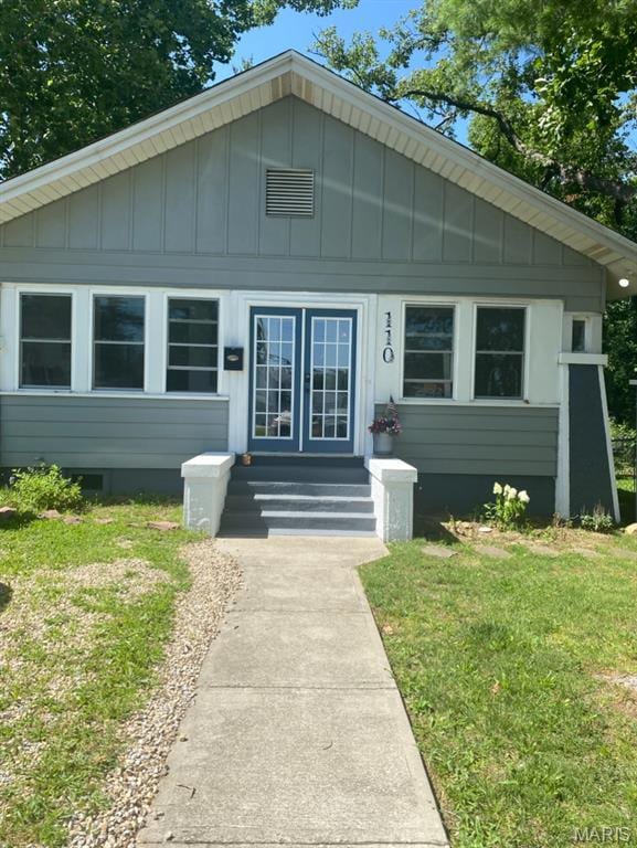 110 Brand Pl, Bonne Terre, MO 63628 - bungalow-style home featuring board and batten siding, a front yard, french doors, and entry steps
