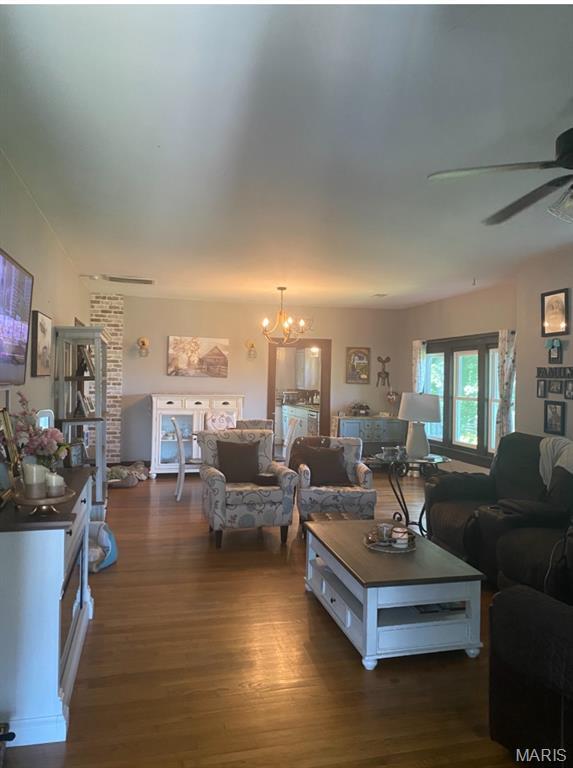 110 Brand Pl, Bonne Terre, MO 63628 - living room with a ceiling fan, dark wood-style floors, and a chandelier