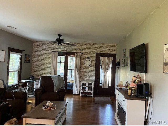 110 Brand Pl, Bonne Terre, MO 63628 - living area featuring dark wood-type flooring, ceiling fan, brick wall, and french doors