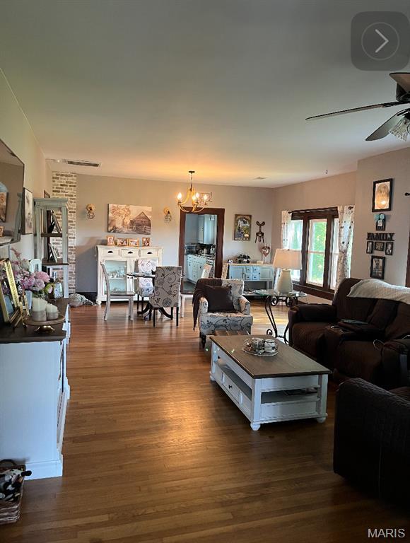 110 Brand Pl, Bonne Terre, MO 63628 - living room with wood finished floors, ceiling fan, and a chandelier