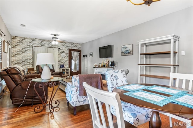 110 Brand Pl, Bonne Terre, MO 63628 - dining room featuring ceiling fan, wood finished floors, and an accent wall