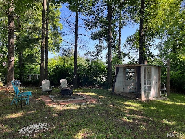 110 Brand Pl, Bonne Terre, MO 63628 - view of green lawn featuring an outdoor fire pit and an outdoor structure