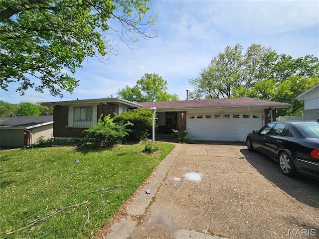 2720 Redman Rd, Saint Louis, MO 63136 - single story home with a garage, driveway, a front lawn, and brick siding