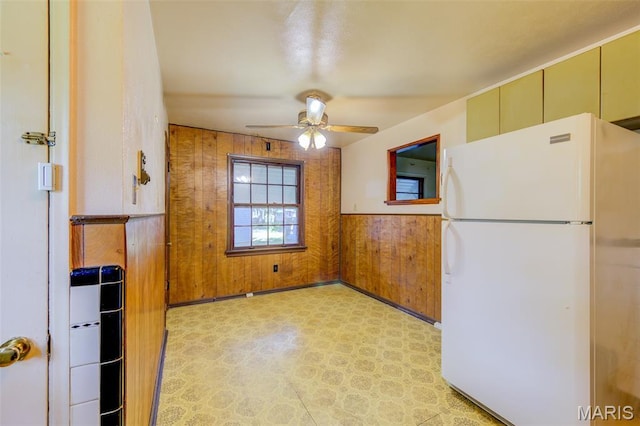 8232 Davenport Dr, Berkeley, MO 63134 - kitchen featuring freestanding refrigerator, ceiling fan, wood walls, light flooring, and wainscoting