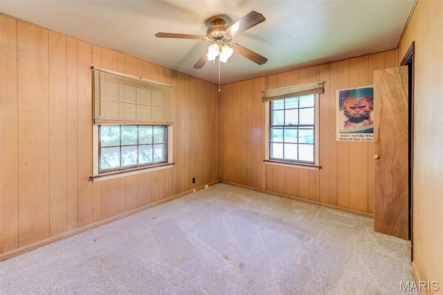 8232 Davenport Dr, Berkeley, MO 63134 - empty room featuring ceiling fan, carpet floors, and wood walls