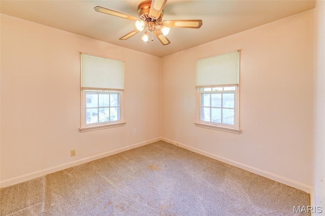 8232 Davenport Dr, Berkeley, MO 63134 - spare room with healthy amount of natural light, carpet flooring, and a ceiling fan