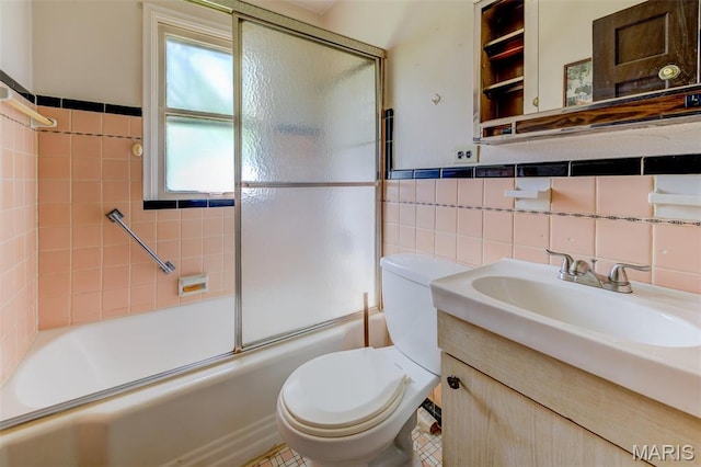 8232 Davenport Dr, Berkeley, MO 63134 - full bath with tile walls, vanity, and bath / shower combo with glass door
