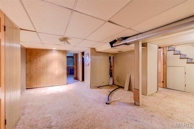 8232 Davenport Dr, Berkeley, MO 63134 - finished below grade area featuring carpet, a paneled ceiling, wooden walls, and stairs