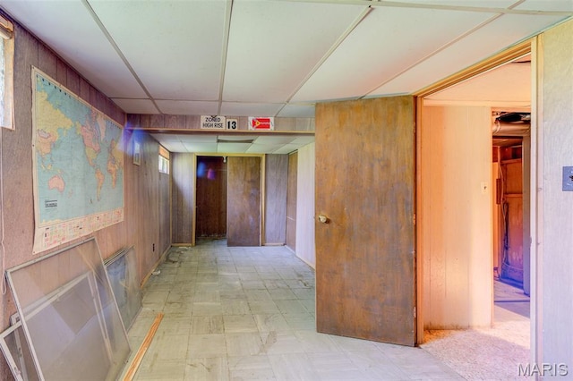 8232 Davenport Dr, Berkeley, MO 63134 - hallway with tile patterned floors, wooden walls, and a paneled ceiling
