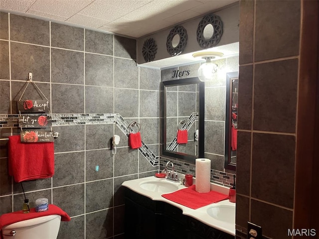 1427 Price Dr, Cape Girardeau, MO 63701 - bathroom with tile walls, double vanity, and decorative backsplash