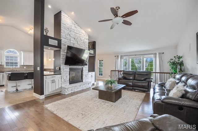 437 Marbleton Cir, Ofallon, IL 62269 - living area featuring a ceiling fan, high vaulted ceiling, light wood finished floors, and a stone fireplace