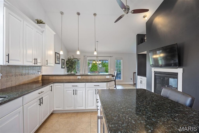 437 Marbleton Cir, Ofallon, IL 62269 - kitchen with ceiling fan, high vaulted ceiling, tasteful backsplash, a glass covered fireplace, and white cabinets