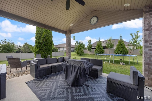 437 Marbleton Cir, Ofallon, IL 62269 - fenced backyard with a trampoline, an outdoor hangout area, a patio area, and ceiling fan