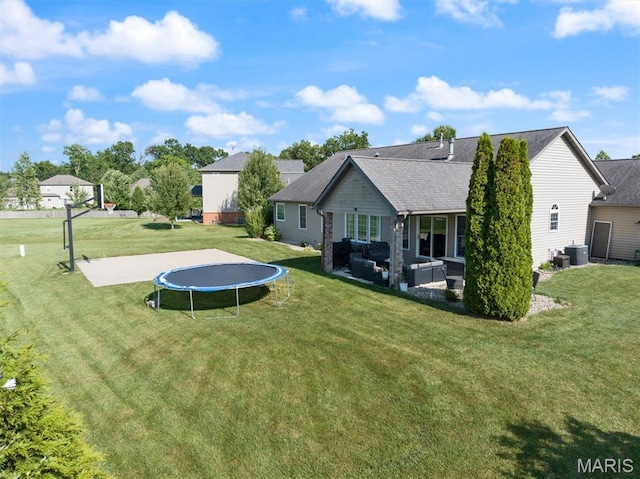 437 Marbleton Cir, Ofallon, IL 62269 - rear view of house featuring a trampoline, an outdoor hangout area, a yard, and a patio