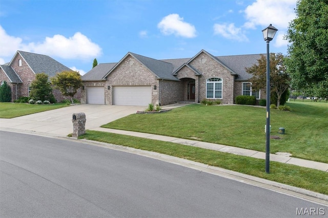 437 Marbleton Cir, Ofallon, IL 62269 - view of front of house with a garage, a front lawn, brick siding, and driveway