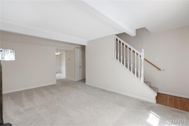 2417 Charente Dr, Maryland Heights, MO 63043 - unfurnished living room with carpet flooring, stairs, and beam ceiling