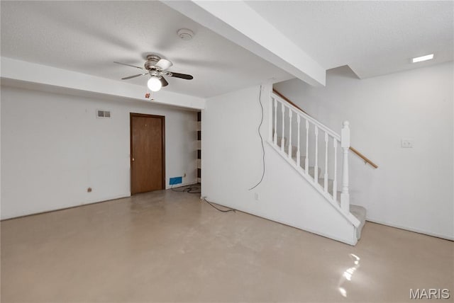 2417 Charente Dr, Maryland Heights, MO 63043 - unfurnished living room with stairs, ceiling fan, concrete flooring, and a textured ceiling