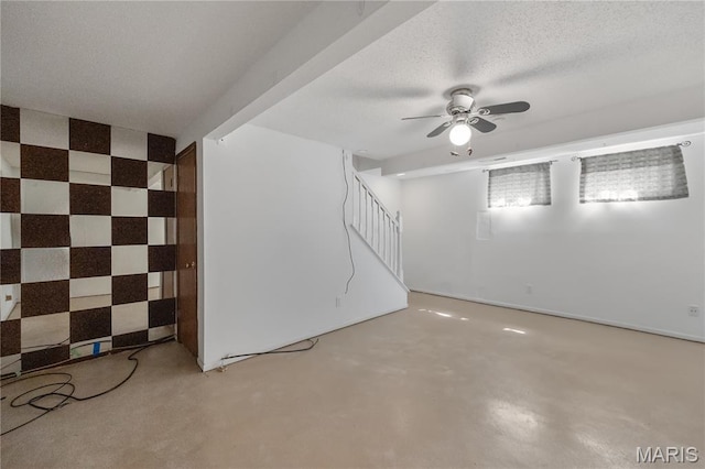 2417 Charente Dr, Maryland Heights, MO 63043 - basement featuring ceiling fan, stairs, and a textured ceiling