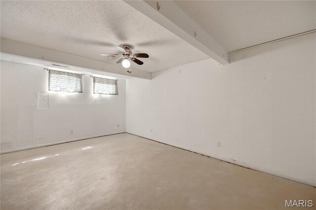 2417 Charente Dr, Maryland Heights, MO 63043 - empty room with ceiling fan, a textured ceiling, beam ceiling, and concrete flooring