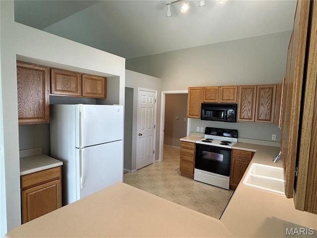 2401 Mountain Range Ct, Pacific, MO 63069 - kitchen featuring white appliances, light countertops, vaulted ceiling, brown cabinets, and light floors